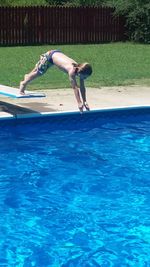 Side view of shirtless man in swimming pool