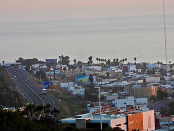 High angle view of buildings and sea against sky