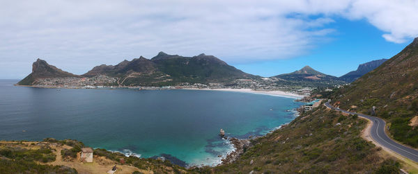 Panoramic view of sea and mountains against sky