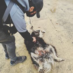 Low section of man standing with dog