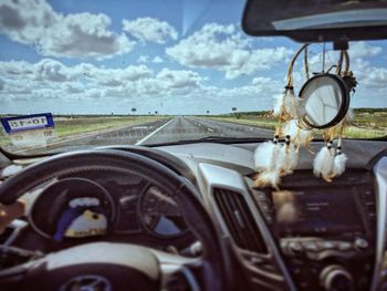 Cars on road against sky