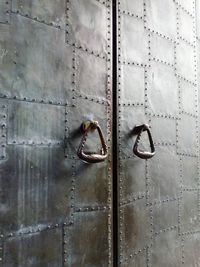 Full frame shot of handles on metallic doors