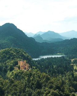 Scenic view of trees and mountains against sky