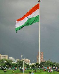 Flag against sky in city