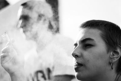 Portrait of young man smoking outdoors