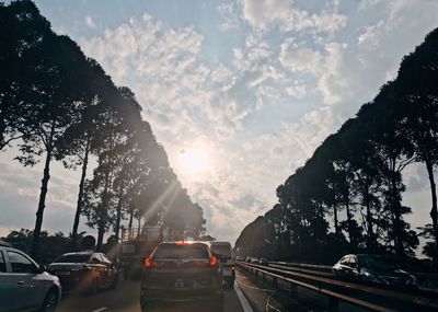 Cars on road against sky