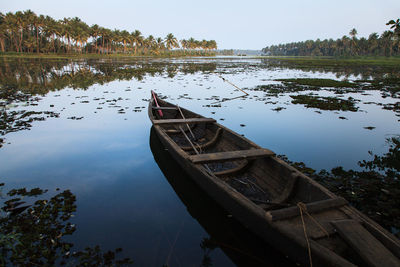 Close-up of boat in lake against sky