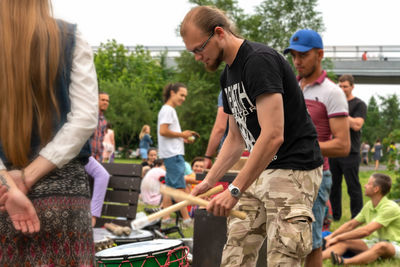 Rear view of people standing outdoors