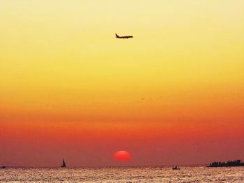 Scenic view of sea against orange sky