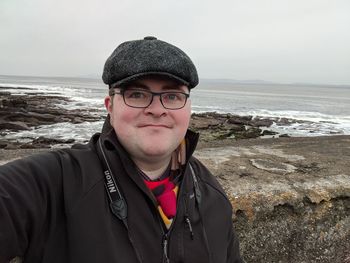 Portrait of man wearing sunglasses at beach