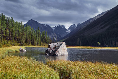 Scenic view of lake and mountains against sky