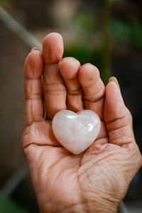 Close-up of hand holding heart shape