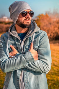 Portrait of young man wearing sunglasses standing outdoors