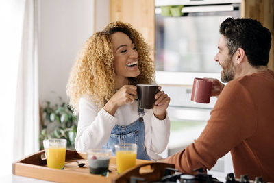 Young couple holding coffee cup