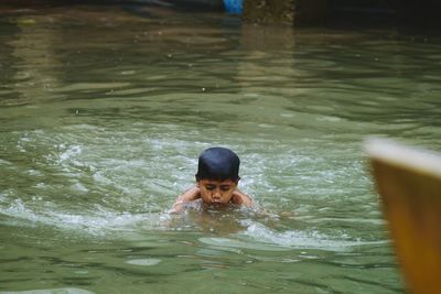 Shirtless boy enjoying in river