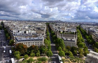 Buildings against cloudy sky