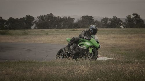 Man riding motorcycle on field