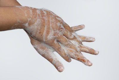 Close-up of human hand against white background
