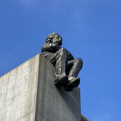 Low angle view of statue against clear blue sky