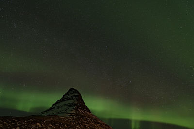 Low angle view of aurora borealis at night during winter