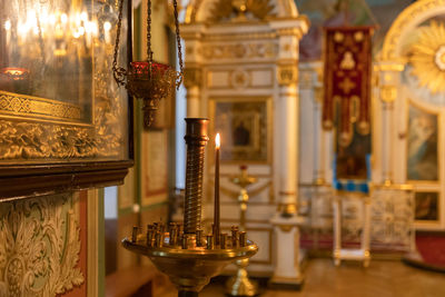 Illuminated candle in church