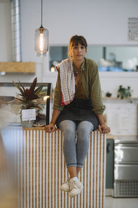 Portrait of woman sitting on table