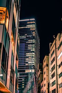 Low angle view of buildings in city at night