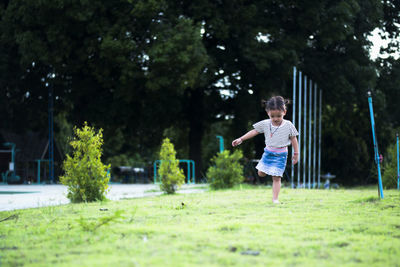 Full length of boy running on field