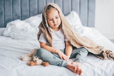 Portrait of young woman sleeping on bed at home