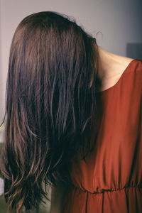 Full length portrait of woman against wall