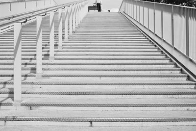 Low section of woman walking on railroad station