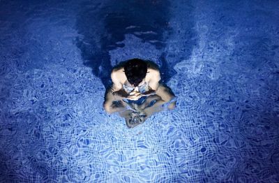 High angle view of woman swimming in pool