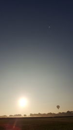 Scenic view of field against sky during sunset