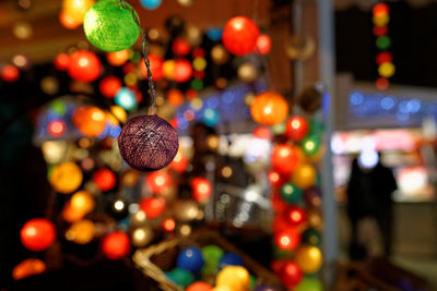 Close-up of illuminated bauble at the champs-elysées christmas market by night