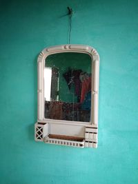 Reflection of window on blue wall