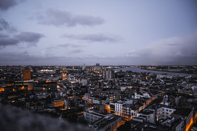 High angle view of illuminated city buildings against sky