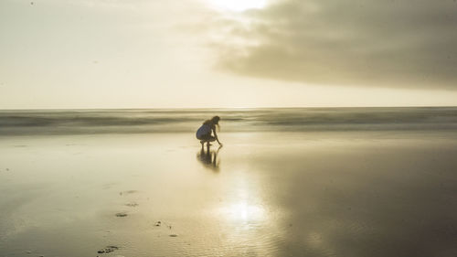 Rear view of man walking on beach