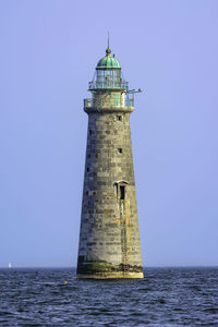 Historic minot ledge light on a clear and calm day near the entrance to cohasset harbor.
