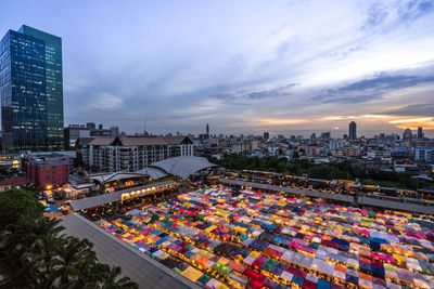 High angle view of illuminated city buildings against sky