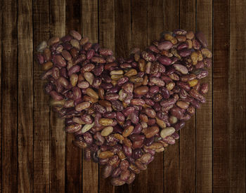 Directly above shot of roasted coffee beans on wood