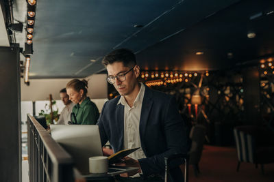 Businessman working on laptop while sitting in hotel