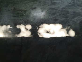 Digital composite image of smoke emitting from water at night