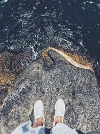 Low section of man standing on rock