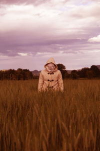 Hay bales on field against sky