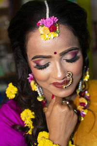 An indian woman wearing traditional dress and flower ornaments