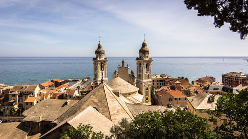 Panoramic view of sea and buildings against sky