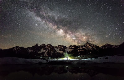 Scenic view of bavarian alps against star field at night