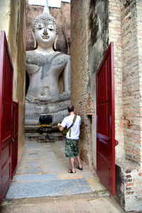 Full length of man standing outside building