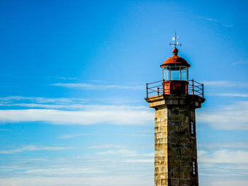 Low angle view of lighthouse against blue sky