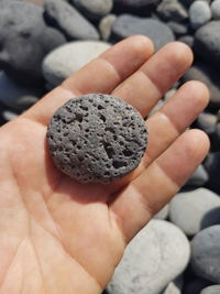 Close-up of person holding pebbles